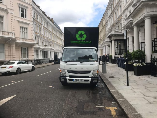 Home-Hero-add-logo Rubbish Disposal white lorry parked outside offices on a typical London street