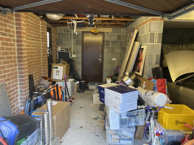 IMG_4234 Garage cluttered with household rubbish with car and bike