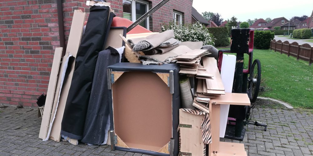 Bulky,Waste,On,The,Street,Is,Waiting,For,Garbage,Collection. Household rubbish piled up outside house