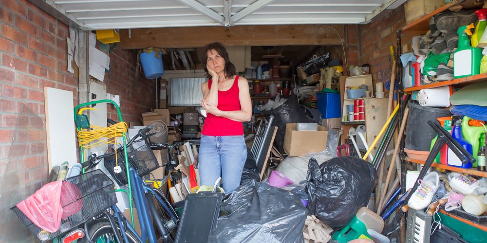 Woman,Looking,Bemused,About,Where,To,Start,In,Clearing,Out Billericay rubbish clearance in woman's garage