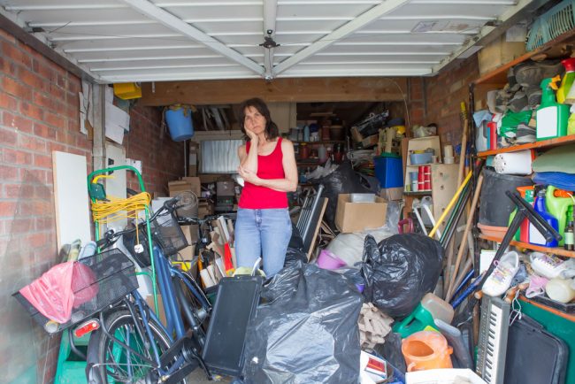 Woman,Looking,Bemused,About,Where,To,Start,In,Clearing,Out Billericay rubbish clearance in woman's garage