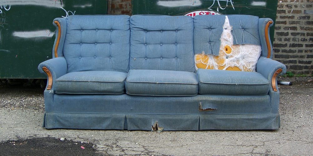Vintage,Old,Grungy,Ripped,Abandoned,Couch,Left,For,Garbage disposing of an old sofa