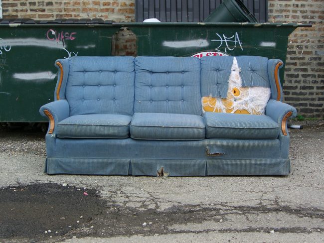 Vintage,Old,Grungy,Ripped,Abandoned,Couch,Left,For,Garbage disposing of an old sofa
