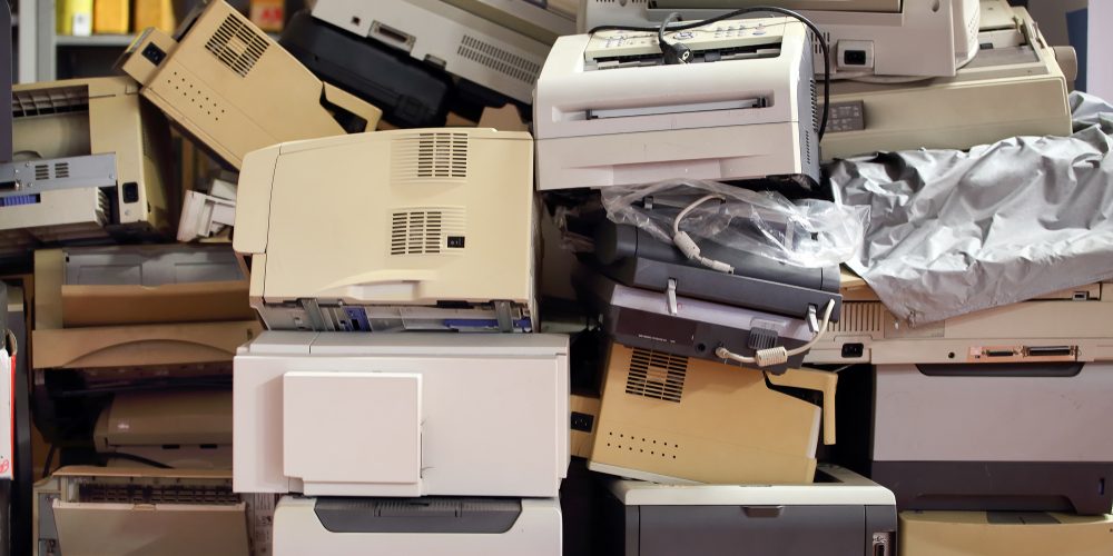 Stack,Of,Disused,Computer,Printers,To,Be,Scrapped,Or,Recycled. a pile of old printers