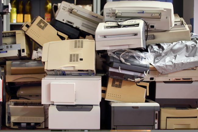 Stack,Of,Disused,Computer,Printers,To,Be,Scrapped,Or,Recycled. a pile of old printers