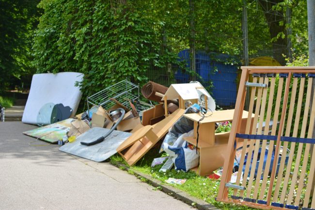 Bulky,Waste,Including,Old,Furniture,,Vacuum,Cleaner,Lying,On,Grass rubbish left on property