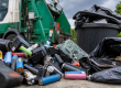 a pile of lithium batteries next to a rubbish truck
