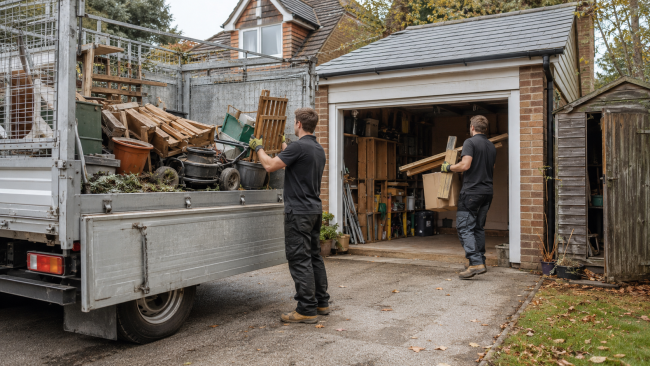 Rubbish clearance team removing unwanted items from a garage in Essex before winter